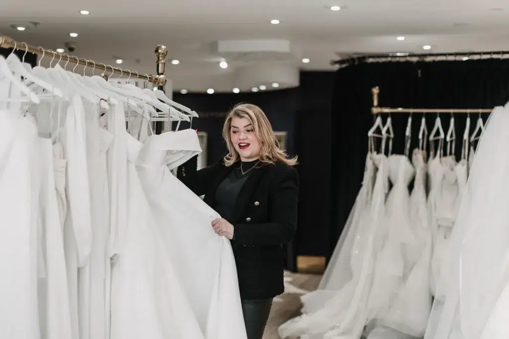 Sian looking at wedding dresses during a bridal appointment.