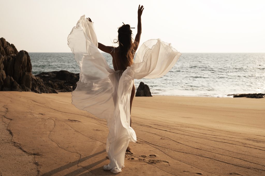 Bride on a beach in a beach wedding dress